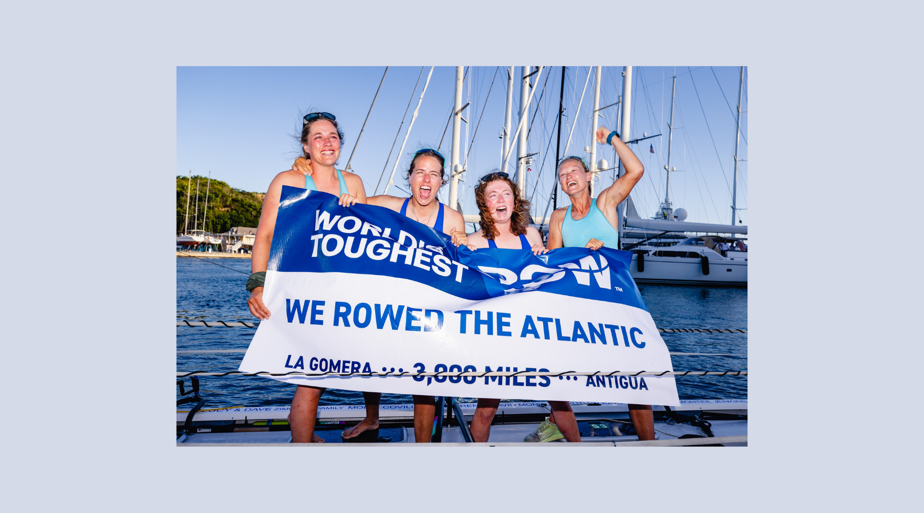 There She Rows holding banner