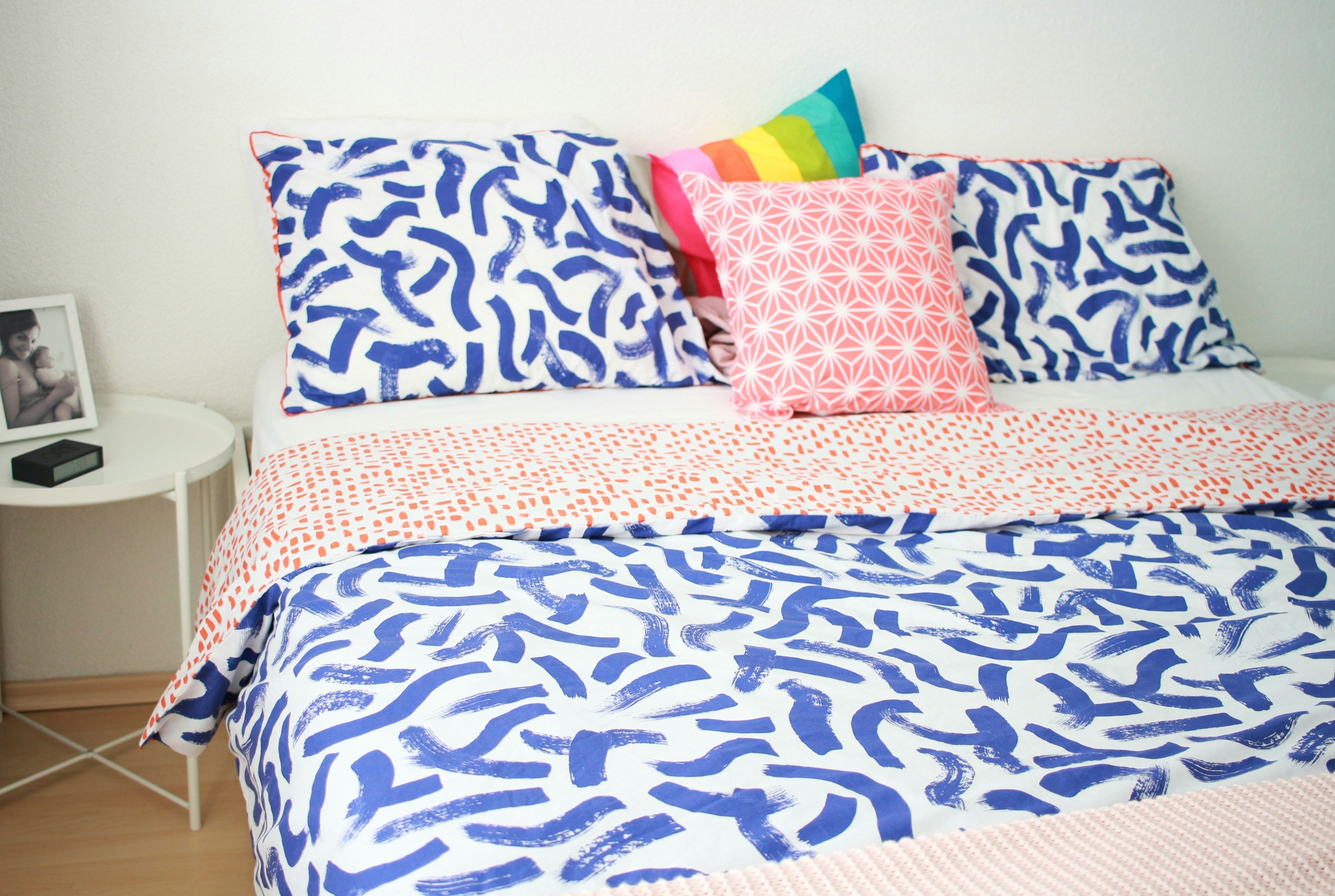 Pride pillow on a comfy-looking bed
